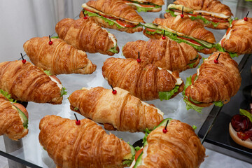 Croissant sandwich on the buffet table. Catering for business meetings, events and celebrations. Close-up.