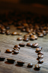 heart shaped coffee beans on wooden background