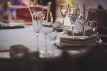 Elegant dinner table setting in restaurant or hotel with wine glasses