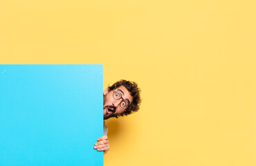 young crazy bearded man expressing a emotion with a copy space