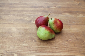 green pear with pink on a wooden table 