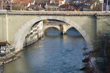 Naklejka premium Bridge Nydeggbrücke (German) with river Aare at the old town of Bern, capital of Switzerland. Photo taken February 24th, 2021, Bern, Switzerland.