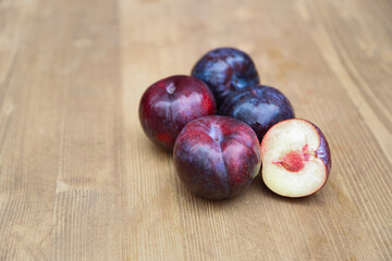plums on wooden background