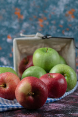 Red and green apples on blue checked kitchen towel