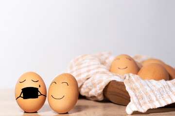 Creative Easter eggs with Corona virus protection, egg in a black mask in a quarantine. Diverse chicken eggs with smile on grey background. Flat lay, top view, mockup, copy space.