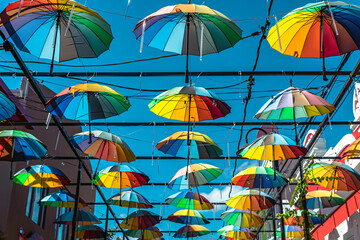 Fototapeta na wymiar multicolored umbrella against the sky