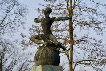 Bronze sculpture of man near the Federal Palace of Switzerland (German Bundeshaus) , residence of national Swiss government and parliament. Photo taken February 24th, 2021, Bern, Switzerland.