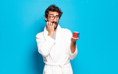young bearded man wearing bathrobe solving a intelligence problem