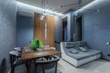 interior photography, large kitchen studio together with living room in loft style, in dark colors