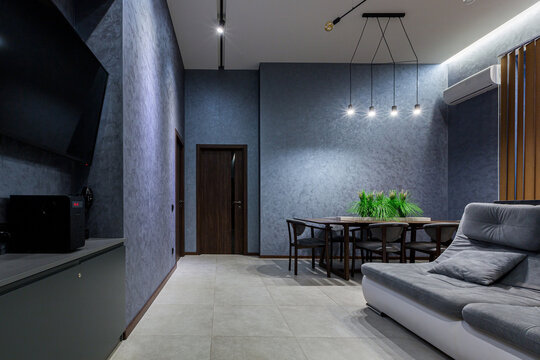 interior photography, large kitchen studio together with living room in loft style, in dark colors