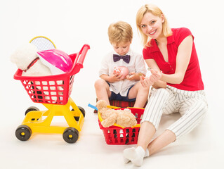 Family relationships. Son with mother plays in shop. Playing supermarket.