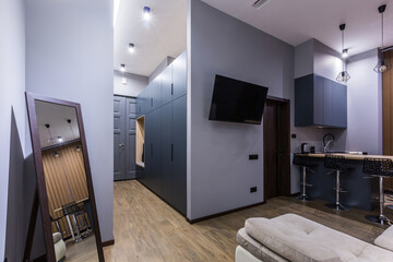 interior photography, large kitchen studio together with living room in loft style, in dark colors
