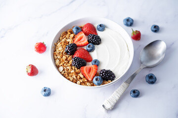 Fresh breakfast with greek yogurt nuts oatmeal granola with berries in a bowl