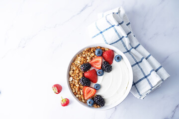 Obraz na płótnie Canvas Fresh breakfast with greek yogurt nuts oatmeal granola with berries in a bowl