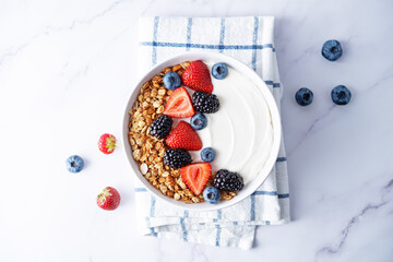 Fresh breakfast with greek yogurt nuts oatmeal granola with berries in a bowl