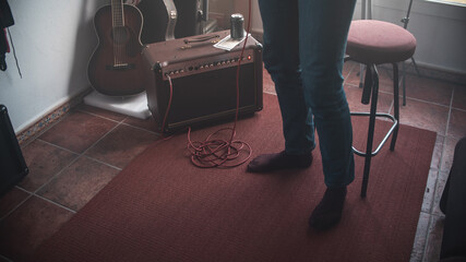 Guitarist in the recording studio composing a song. Concepts of singer-songwriter, electric guitar, band, learning, indie and alternative music