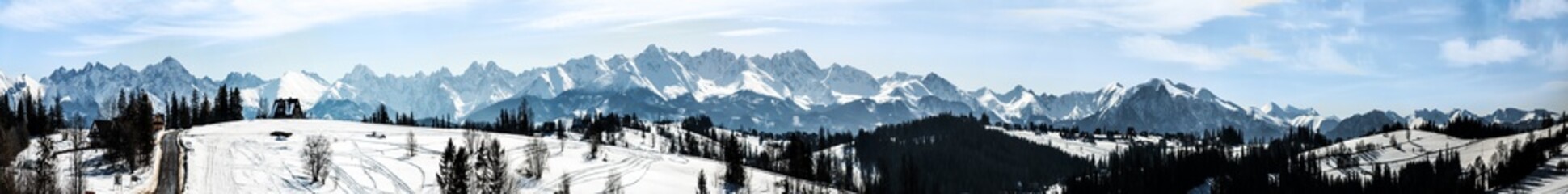 Extra wide panorama of Tatra mountains in winter viewed from Bukowina Tatrzanska in Poland. Good for a banner.