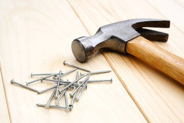 Hammer and nails on the wood background