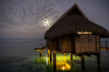 Overwater bungalow at night 