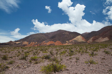 Volcanic landscape in the cordillera. View of the arid desert and colorful mountains under a beautiful sky. 
