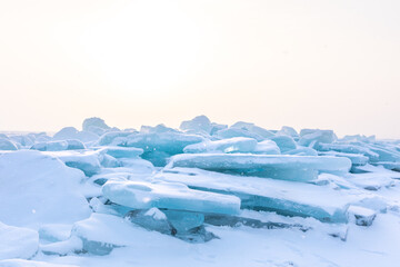 Fototapeta na wymiar Snowy sunrise over the blue ice of Mackinaw City