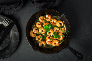 Shrimps with garlic, olive oil and parsley in frypan