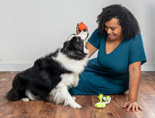 young woman and dog at happy and playful moments in life