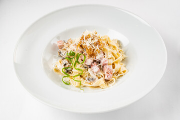 Carbonara pasta, spaghetti with pancetta, egg, hard parmesan cheese and cream sauce.