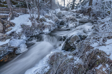Fototapeta na wymiar Ramsaubach creek near Ramsau ski town in Austria in frosty morning