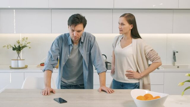 Man and woman screaming at each other in the kitchen. Slow motion