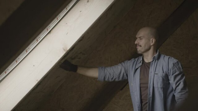 Handyman putting insolation in a wall