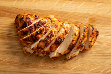 sliced chicken breast on wooden cutting board