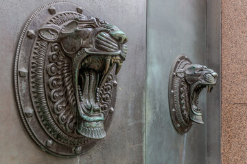 Bronze tiger heads (doorway in Liverpool, UK)