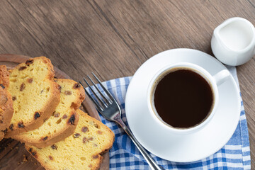Sliced sultana pie served with a cup of coffee