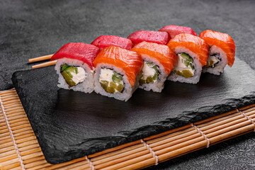 Philadelphia roll sushi with salmon, smoked eel, cucumber, avocado, cream cheese, red caviar. Sushi menu. Japanese food.