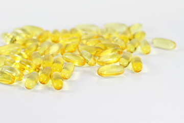Yellow medicine capsule, omega 3 pills, vitamin E health treatment, fish fat for skin hair care on...