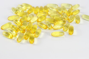Yellow medicine capsule, omega 3 pills, vitamin E health treatment, fish fat for skin hair care on...