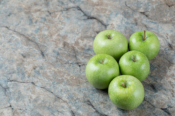 Green apples isolated on a grey marble background