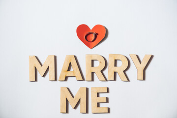 Alphabet letter wooden letters with words Marry me. Marriage proposal and love concept for Valentine`s day with wedding or engagement 