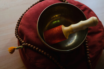 .Tibetan bowl on a meditation cushion