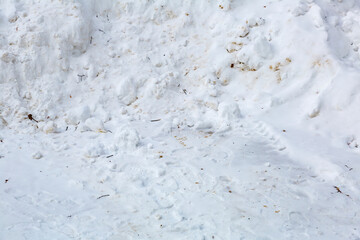 Textured surface of dirty snowdrift on winter day