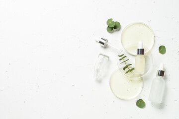 Essential oil, eucalyptus oil . Glass petri dish with essential oil at white background.