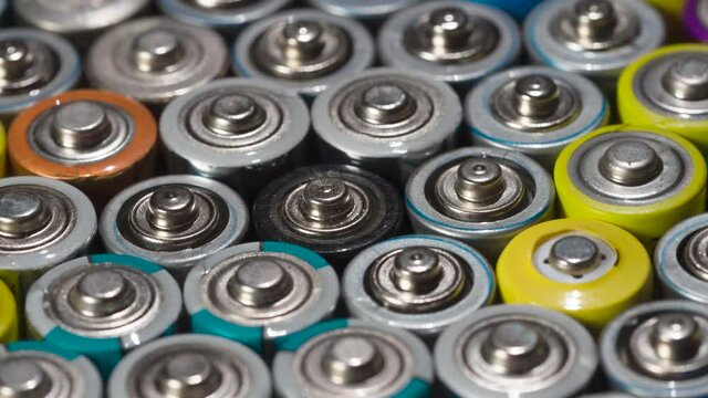 Preparing Bbatteries for Recycling. Dense array of AA batteries moving with slight rotation close-up