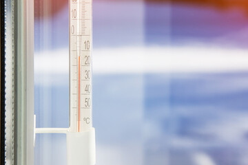 The outdoor thermometer on the window shows a low temperature in Celsius