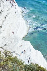Fotobehang Scala dei Turchi, Sicilië Tourists stroll and sunbathe at the "Scala dei Turchi" (scale of the Turks) located in the province of Agrigento, Sicily