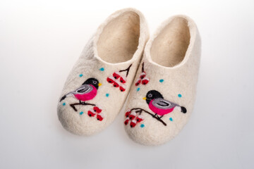 Beautiful warm felt slippers. Handmade. Decorated with the image of the spot bullfinch branch of mountain ash.