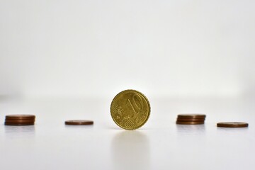 10 cents coin close up on blurred background with other coins