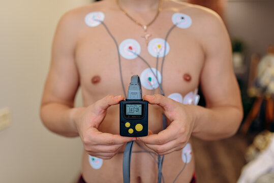 Heart electrocardiogram or monitoring using Holter for young patient. Male athlete does a cardiac stress test. wearing Holter monitor device for daily monitoring of an electrocardiogram. 