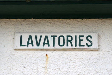 Close Up of 'Lavatories' Sign on Wall of Public Building