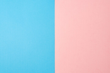 Background of two vertical rectangles blue and pink. Sheets of blank blue and pink paper split...